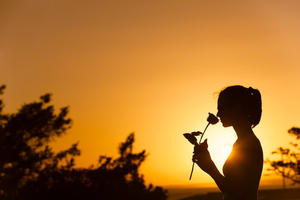 mesothelioma patient smelling a rose