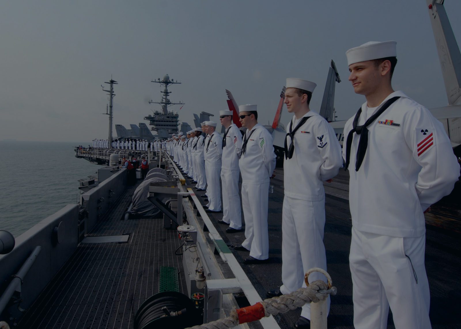 Sailors man the rails aboard the aircraft carrier USS George Washington